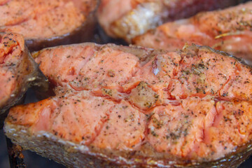 Large fish steaks fresh trout fried in spices on the grill