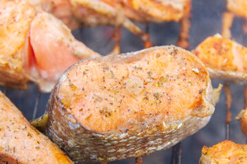 Large fish steaks fresh trout fried in spices on the grill