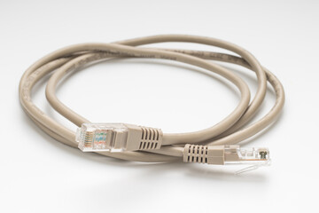 Coiled computer internet cable on white background