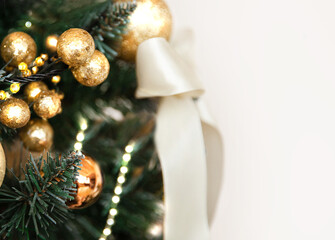 Christmas decorations Golden balls and a bow on spruce branches on a white background in large numbers.