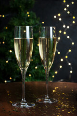 Pair glasses of champagne on holiday background with color decoration