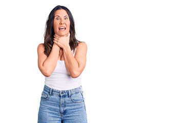 Fototapeta premium Young beautiful brunette woman wearing casual sleeveless t-shirt shouting and suffocate because painful strangle. health problem. asphyxiate and suicide concept.