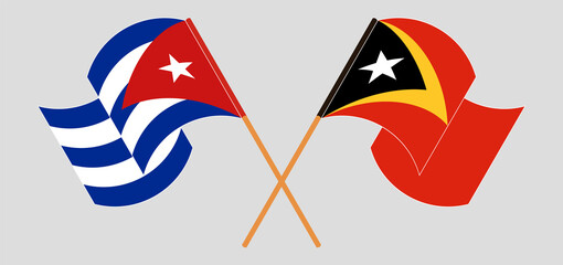 Crossed and waving flags of Cuba and East Timor