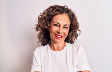 Middle age beautiful brunette woman wearing casual t-shirt standing over white background happy...