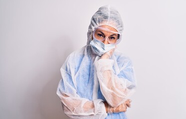 Middle age nurse woman wearing protection coronavirus equipment over white background thinking looking tired and bored with depression problems with crossed arms.
