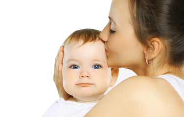Portrait close up of happy mother kissing her cute baby over a white background