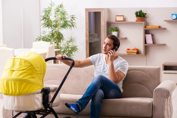 Young male contractor looking after new born at home