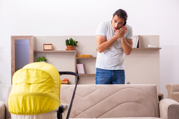 Young male contractor looking after new born at home