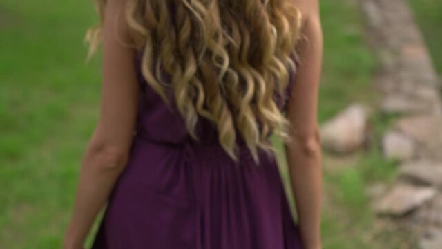 back view of a woman with beautiful long blond hair