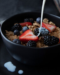 Breakfast cereal with fresh berries and a splash of milk