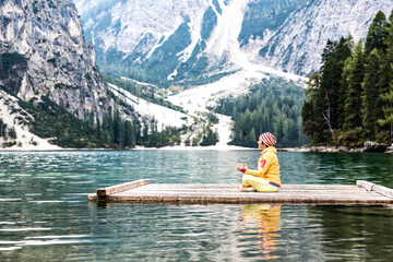 Italien, Südtirol, Pustertal, Pragser Wildsee, Frau praktiziert Yoga auf einem Floss