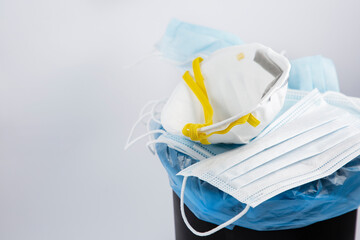 Doctor mask to Used mask for wearing germ protection Coronavirus or covid 19 for doctors into a trash bin in isolated on white background, disposing of surgical masks responsibly after use Concept