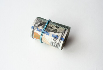 Dollars rolled into a tube on a white background
