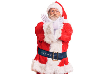 Old senior man with grey hair and long beard wearing traditional santa claus costume rejection expression crossing arms doing negative sign, angry face