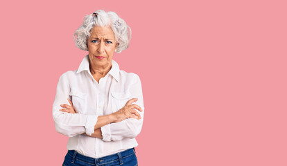 Senior grey-haired woman wearing casual clothes skeptic and nervous, disapproving expression on...