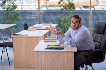 Young male teacher in the classroom