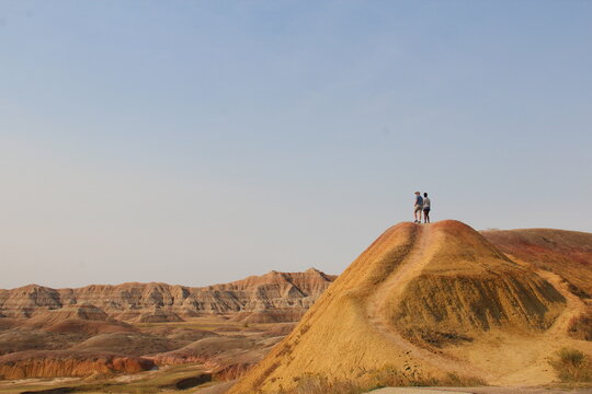 Two People On Top Of Mountain In Badlands National Park, South Dakota