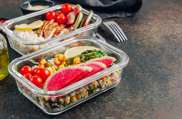 Meal prep containers with chicken, rice, avocado, tomato, corn, peas, watermelon radish, asparagus