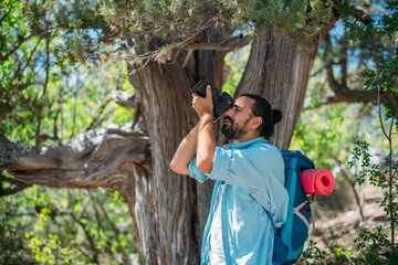 Male photographer with a camera on a hike.