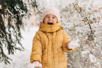 Toddler girl happy with snow day in winter. Playing outside on Christmas holiday
