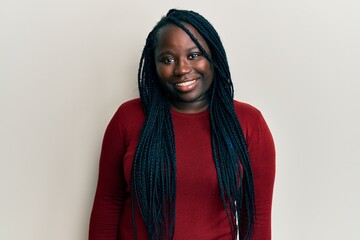 Young black woman with braids wearing casual clothes with a happy and cool smile on face. lucky person.