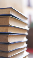 several books stacked in a tower on a desk