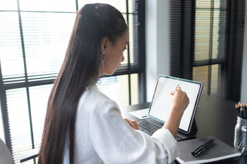Businesswoman hand working with digital tablet with stylus pen on worktable