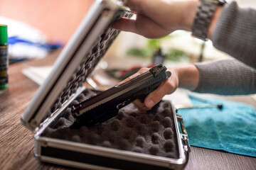 Man putting gun in safe box