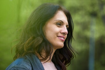 Portrait of a beautiful middle-age woman smiling. Outdoors