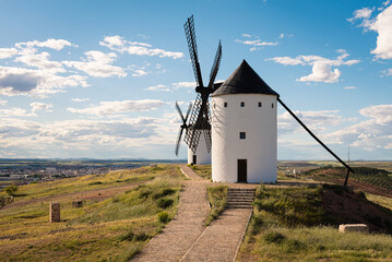 Exterior view of windmills on landscape in spring in Alcazar de San Juan, Ciudad Real, Spain
