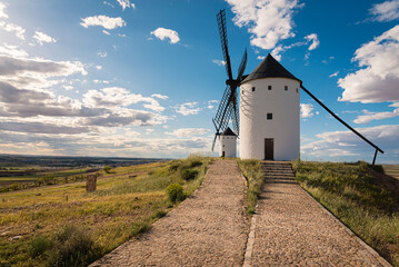 Exterior view of windmills on landscape in spring in Alcazar de San Juan, Ciudad Real, Spain