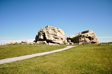 Big Rock Erratic. This massive and unusual rock formation near Okotoks, Alberta, Canada is the world's largest glacial erratic. Large chunks of rock left by ice age glaciers on otherwise flat ground. 