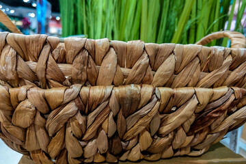 Close-up on a beautiful wicker basket on the table.