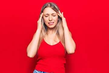 Young blonde woman wearing casual clothes with hand on head for pain in head because stress. suffering migraine.