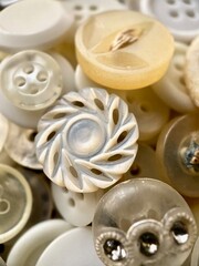 White, off-white and cream antique or vintage sewing buttons: Celluloid Buttons, Bakelite Buttons, Lucite Buttons, Vegetable Ivory, metal, China, glass, and mother of pearl. 