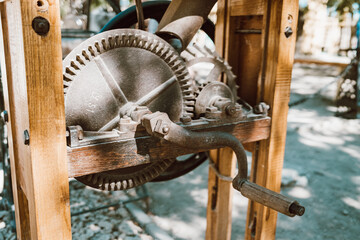 Well lifting mechanism close-up. Gate raising gear at medieval fortress. Rusty wheel and cog of manual antique machinery.