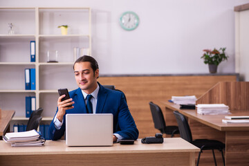Young male employee working in the office