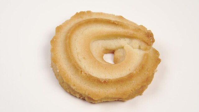 One round buttery cookie on white. Macro shot. Rotation. Close up