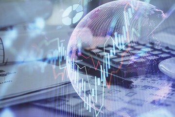 Obraz premium Double exposure of financial chart drawings and desk with open notebook background. Concept of forex market