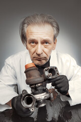 Man checking and measuring carbonized turbocharger on table