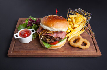 Gourmet burger with ham and fried onion and potatoes