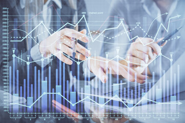 Multi exposure of man and woman working together and financial chart hologram. Business concept. Computer background.