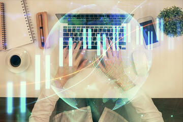 Double exposure of woman hands working on computer and forex chart hologram drawing. Top View. Financial analysis concept.