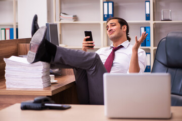Young male employee extremely tired with excessive work