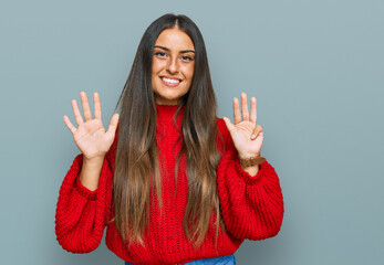 Beautiful hispanic woman wearing casual clothes showing and pointing up with fingers number nine...