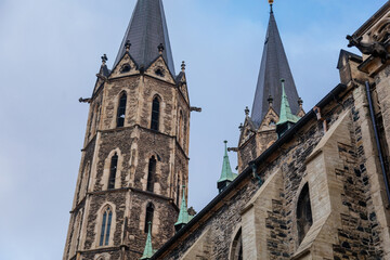 Fototapeta na wymiar Medieval stone St. Bartholomew´s Church in autumn day, arched windows, chimeras and gargoyles, Gothic Cathedral with belfry in Kolin, Central Bohemia, Czech republic