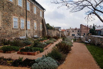 Green outer bailey park, rose and herb garden near Regional Dvorak´s Museum, Gothic Cathedral, Medieval stone St. Bartholomew´s Church, Kolin, Czech republic