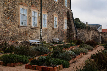 Green outer bailey park, rose and herb garden near Regional Dvorak´s Museum, Gothic Cathedral, Medieval stone St. Bartholomew´s Church, Kolin, Czech republic