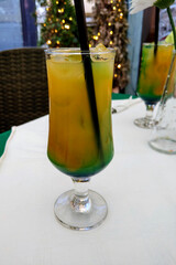 View of a cool glass of cocktail on a table on a hot day, freshness, coolness.