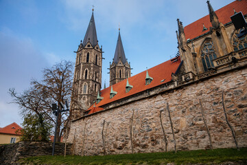 Fototapeta premium Medieval stone St. Bartholomew´s Church in autumn day, arched windows, chimeras and gargoyles, Gothic Cathedral with belfry in Kolin, Central Bohemia, Czech republic